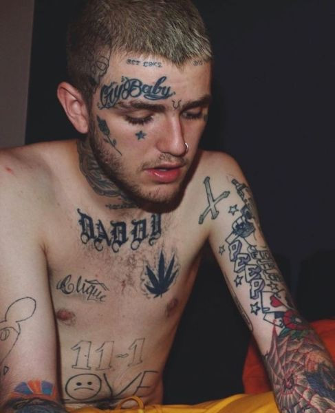 Lil Peep's chest and sternum tattoos including &quot;Clique&quot;, a pot leaf, &quot;11-1&quot;, &quot;No Love&quot;, an inverted cross, stars, &quot;Peep&quot;, and cobwebs.