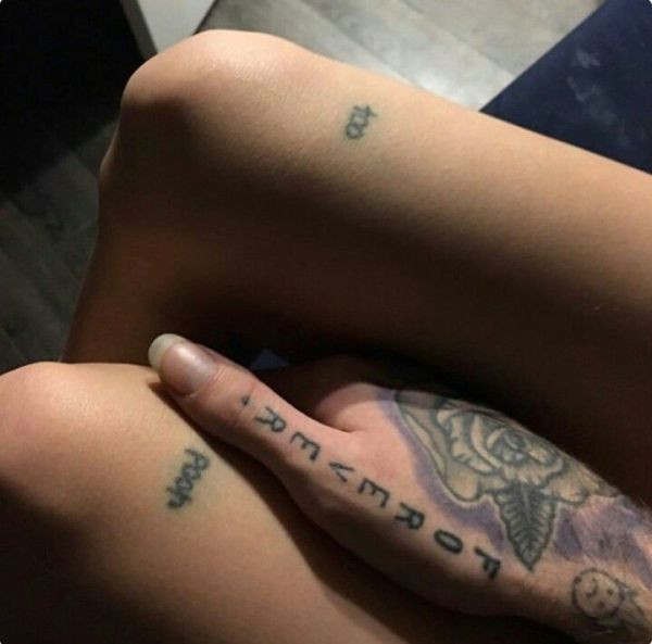 Lil Peep's hand tattoos featuring &quot;Forever&quot; and a frowning face.