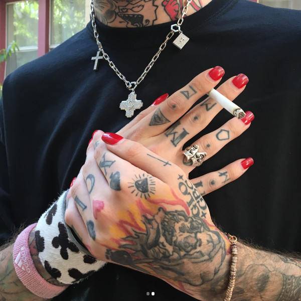 Lil Peep's hand tattoos featuring a Grim Reaper, a diamond, a Playboy logo, &quot;Home Sick&quot;, playing card suits, &quot;GLO GBC&quot;, a cross, and roman numerals.