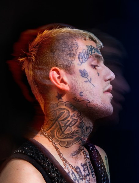 Lil Peep's neck and jaw tattoos featuring &quot;Rip&quot;, a star, a wave, a moon, and a skull.