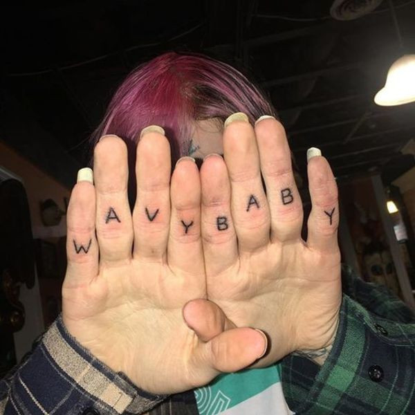 Lil Peep's finger tattoos spelling &quot;Wave Baby&quot;.