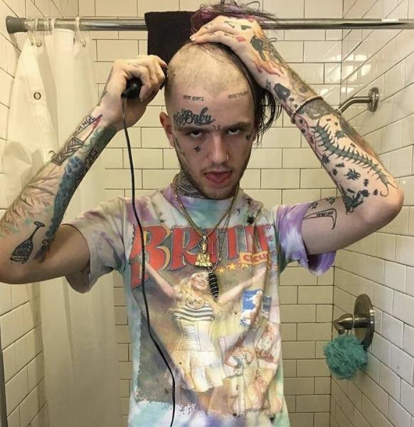 Lil Peep's arm tattoos including a wine glass, a bloody knife, a centipede, bugs, and a coffin.