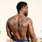 Kevin Hart shirtless showing his tattoos