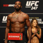 Close-up of Jon Jones' Gaidojutsu tattoo on his left ribs during the UFC 247 weigh-ins, showcasing the vertical Japanese Kanji symbols representing his martial arts style.