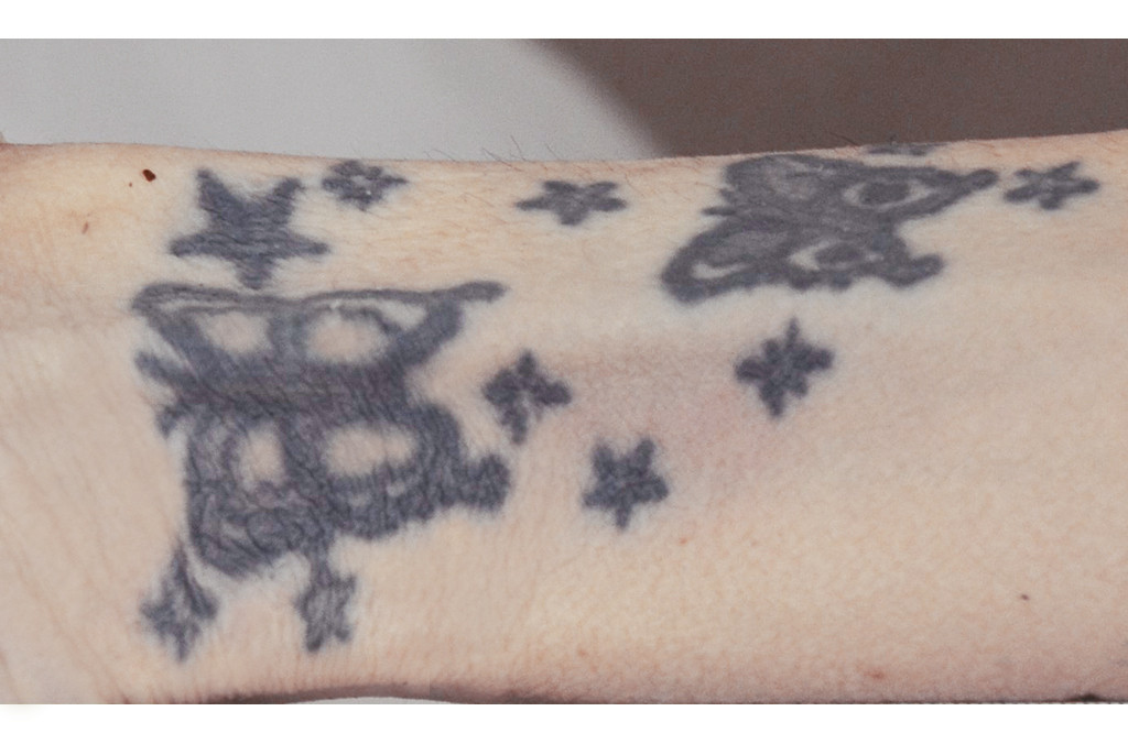 Two butterflies and stars tattoo on the inside of the right wrist, demonstrating a delicate design and popular placement for women.