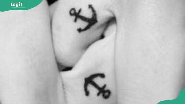 Anchor wedding ring tattoo symbolizing stability, loyalty, and grounding in a relationship.
