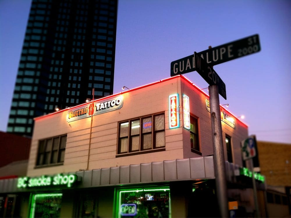 Electric 13 Tattoo artist at work in Austin TX, showcasing the shop's professional environment.