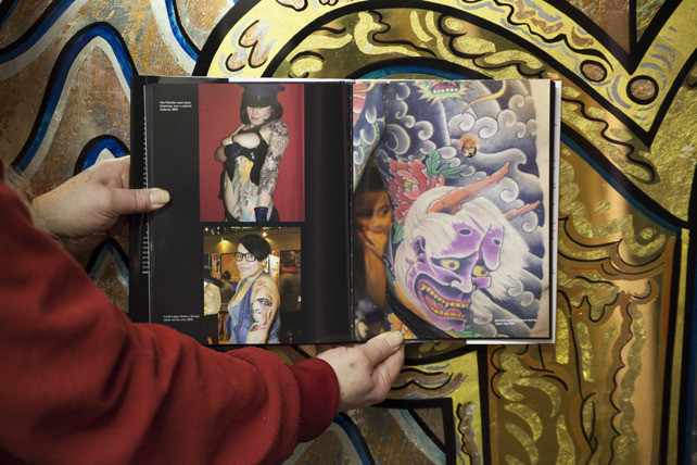 Jonathan Shaw, a prominent figure in the New York tattoo scene, captured in action.
