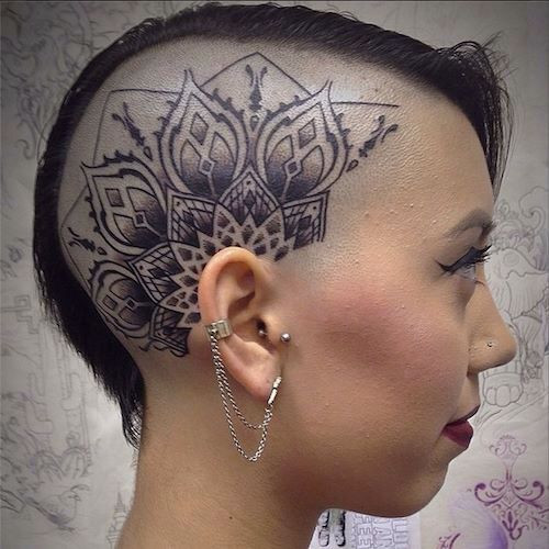 Elaborate mandala head tattoo for women, incorporating floral motifs and intricate dot patterns.