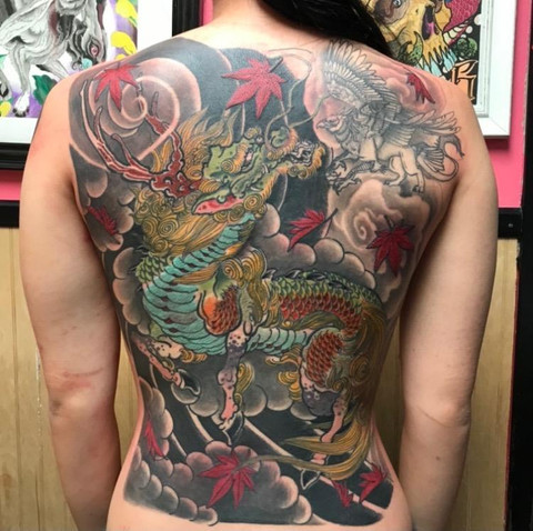 Powerful dragon back tattoo in black and gray by Dave Nyegaard