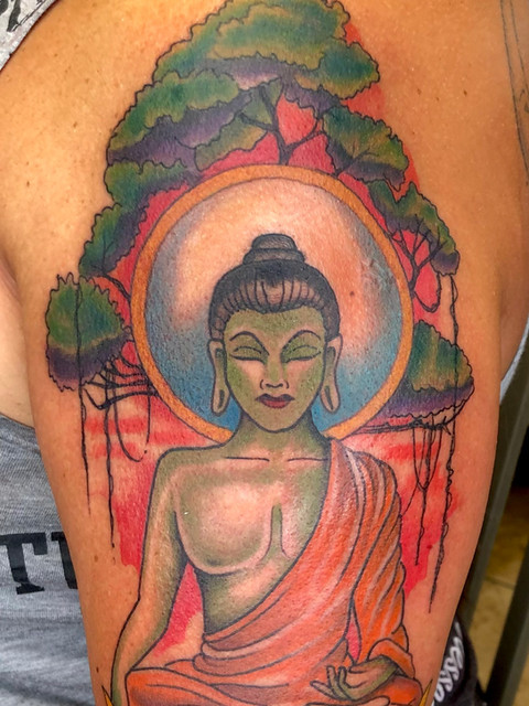 Serene Buddha tattoo in black and gray by Kevin Craig, reflecting peaceful ink therapy