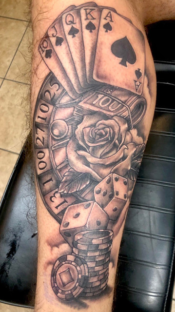 Gambling themed tattoo in black and gray by Kevin Craig