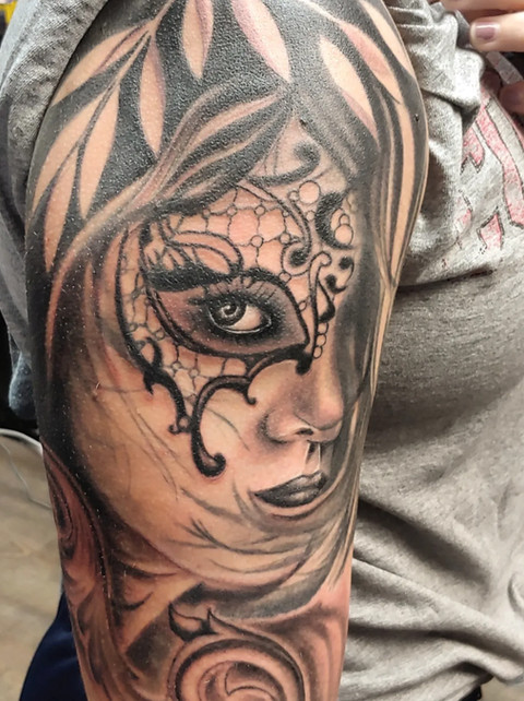 Detailed black and gray tattoo of a masked geisha by Joe Dillon, showcasing ink therapy artistry