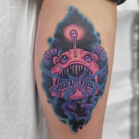 Detailed black and gray tattoo of an angler fish by Jenna Totten