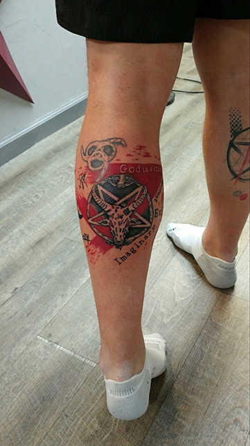 Trash polka style leg tattoo with vibrant colors and chaotic elements by Joe Dillon