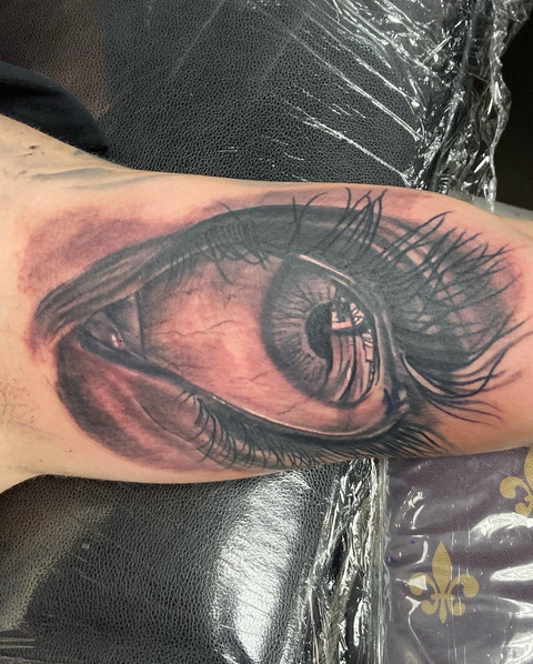 Intense black and gray tattoo of a realistic eye by Dave Nyegaard