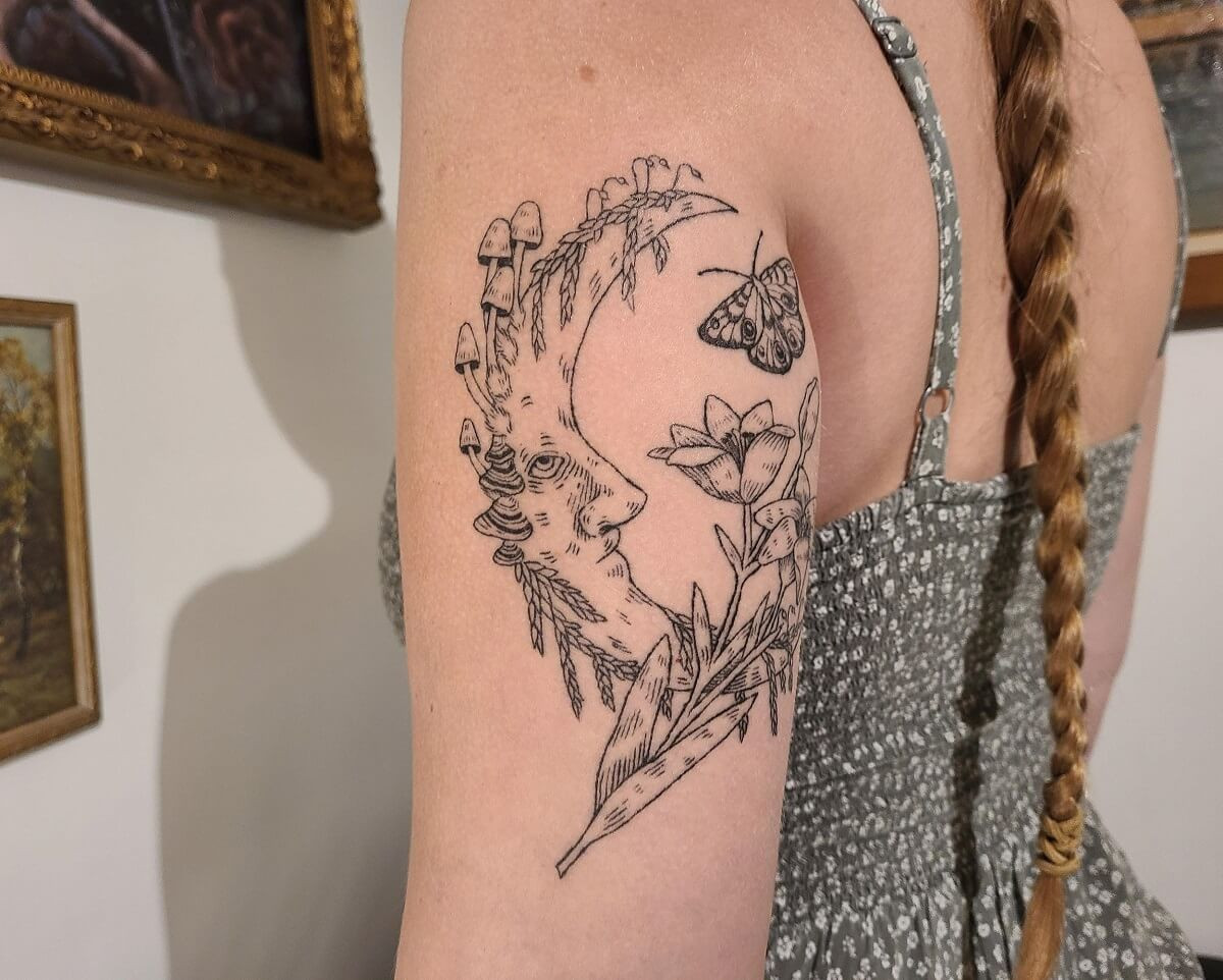 A client showcases their healed etching style tattoo by Leo Mortem, highlighting the intricate detail and lasting artistry.