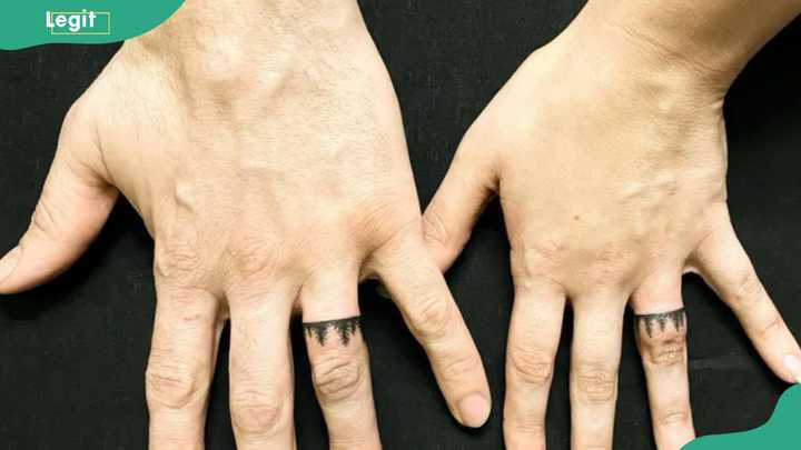 Tree wedding ring tattoo symbolizing growth, strength, and enduring love.