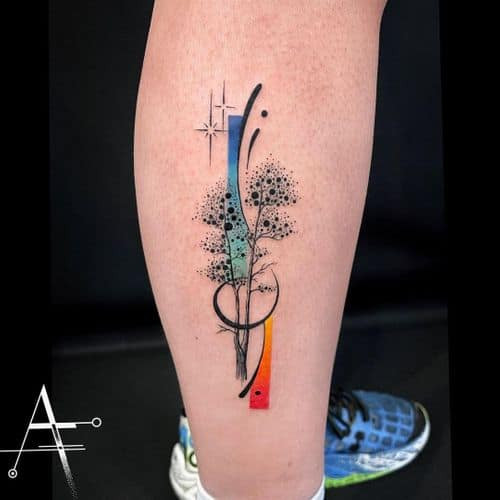 An abstract tattoo with brushstrokes and colors on a man's arm, artistic and expressive