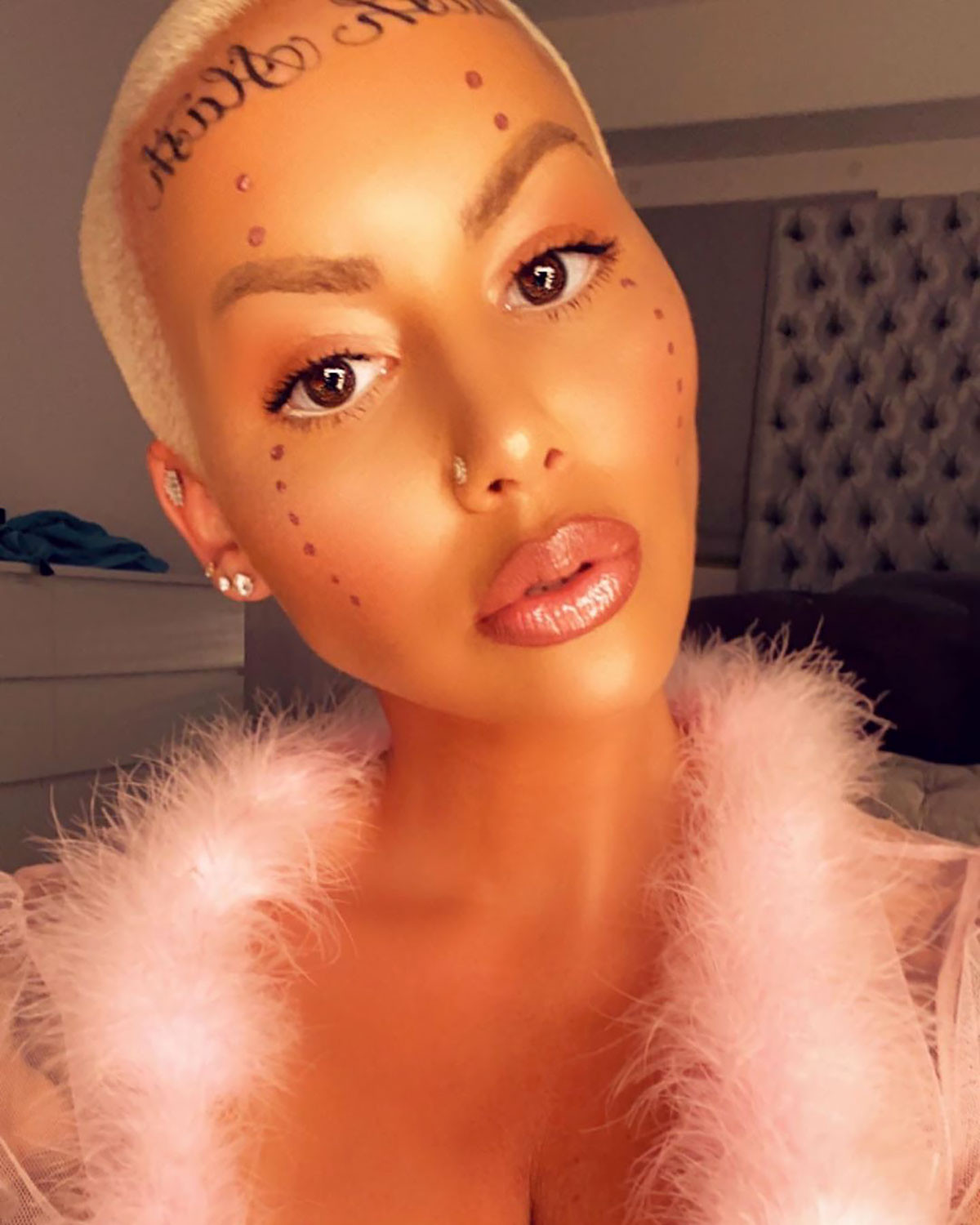 Close-up of Amber Rose's 'Bash Slash' face tattoo, emphasizing the script font and placement on her forehead.