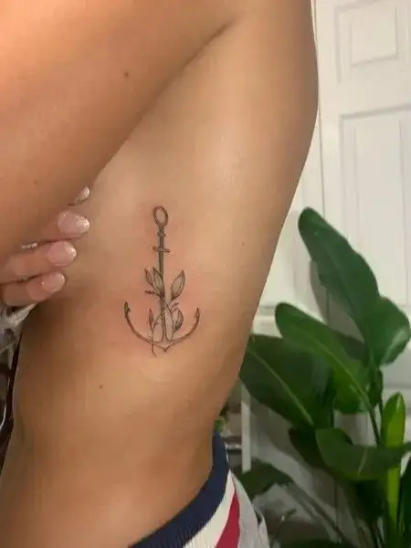 Classic anchor tattoo on the rib cage symbolizing stability