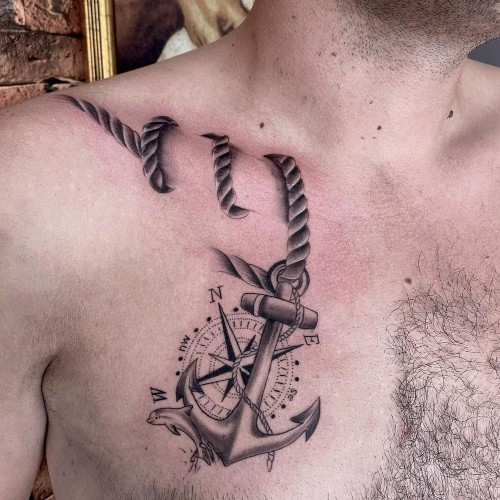 Two anchor tattoos on men, one on the forearm with a traditional anchor and rope and another on the arm with a minimalist anchor outline.