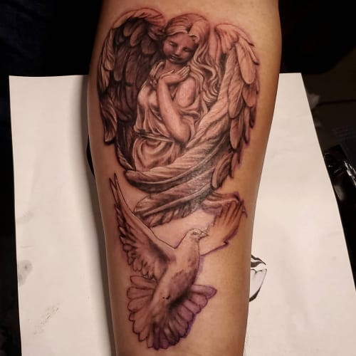 Peaceful angel and dove tattoo, symbolizing inner peace, spiritual cleansing, and divine harmony.