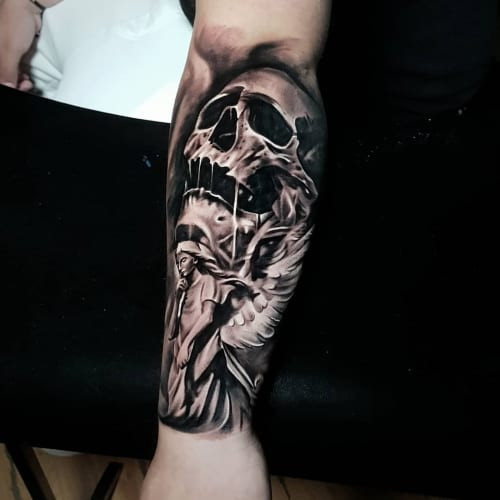 Contrasting angel skull tattoo, exploring the duality of life and death and the protection against mortality.