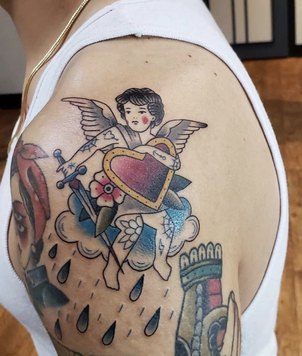 Unique angel heart tattoo, symbolizing love, loss, and deep emotional connections.