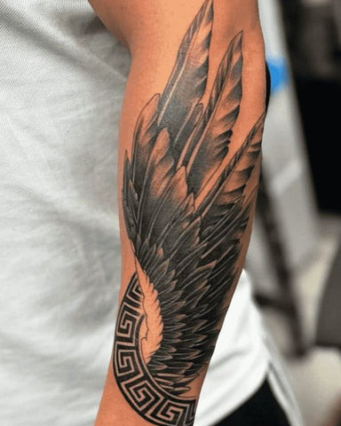 Angel sleeve tattoo featuring angel wings, clouds, and celestial elements in soft colors, symbolizing protection and faith.