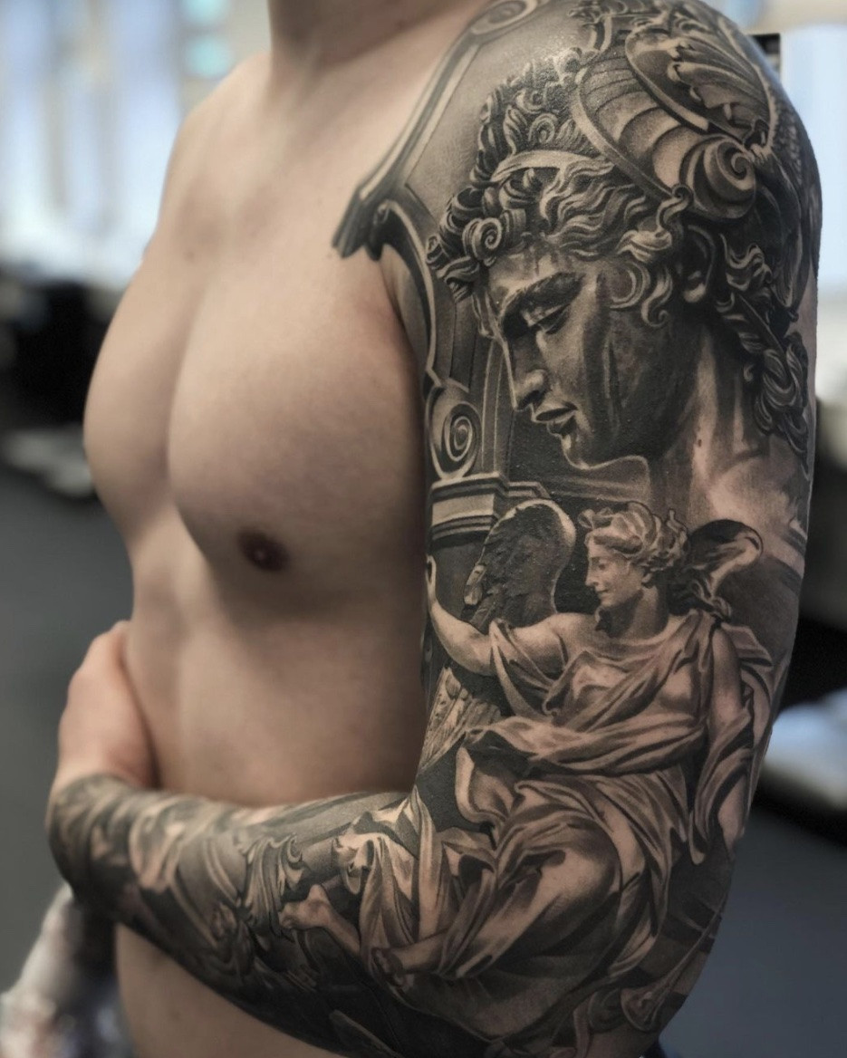 Extensive full angel sleeve tattoo, showcasing dedication, commitment, and elaborate angelic artistry.