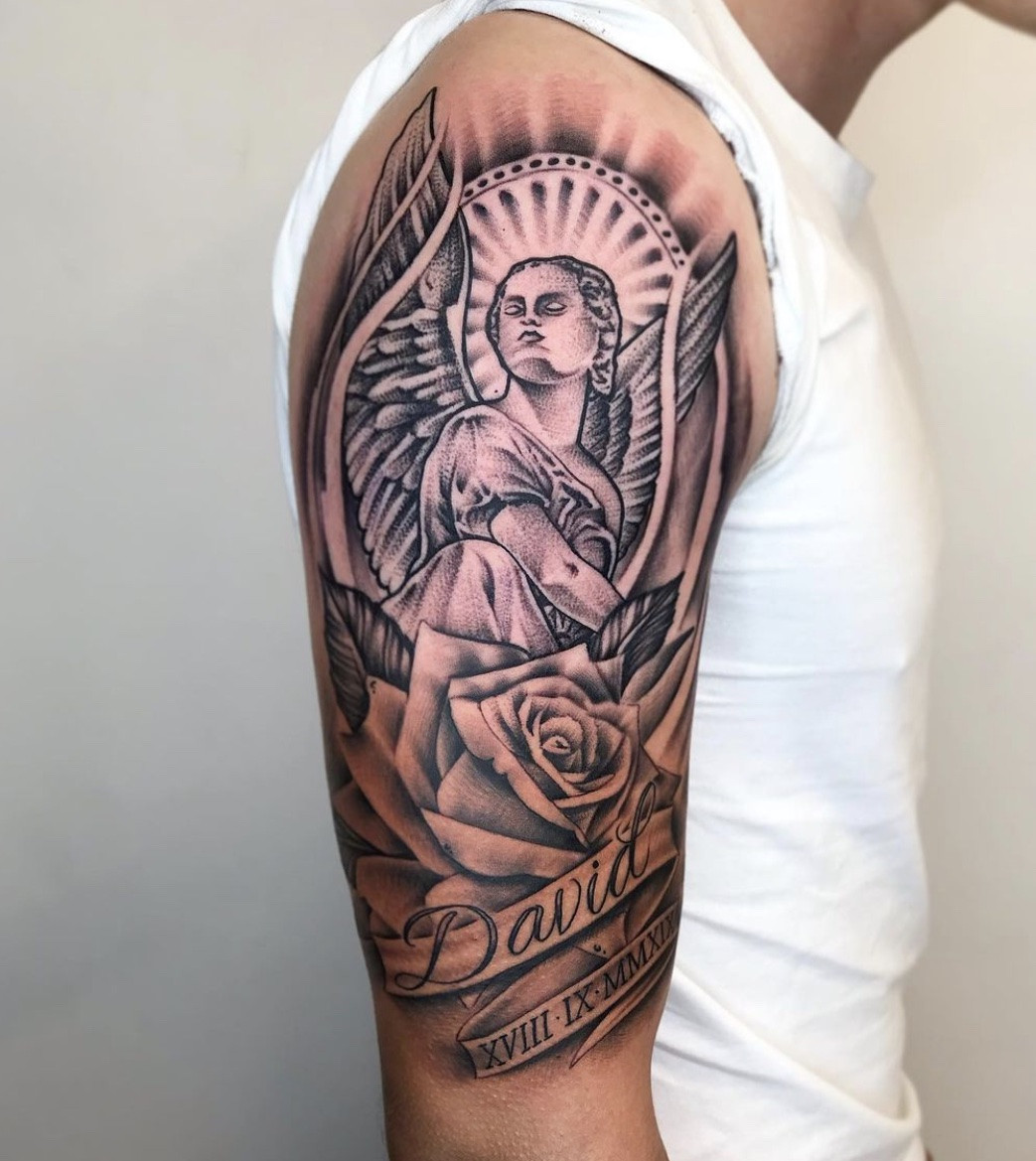 Personalized angel tattoo with name, serving as a memorial and tribute to a loved one.