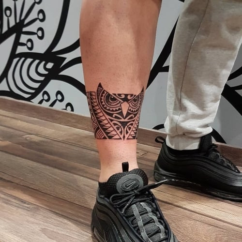 Two ankle tattoos on men, one with an ankle band tattoo and another with a smaller ankle side design.