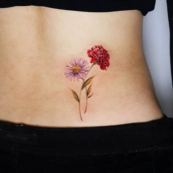 Japanese style aster flower tattoo, incorporating traditional Japanese art elements and color palettes, on the back.