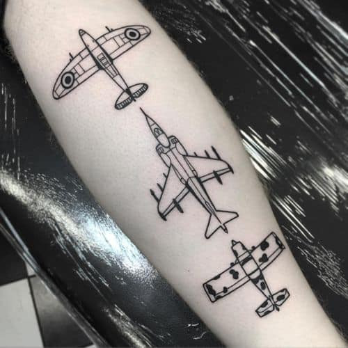 Airplane tattoo on the arm, representing travel in men tattoo ideas.