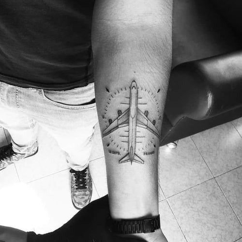 Two aviation tattoos on men, one on the chest with a stylized airplane compass and another on the shoulder with a geometric aviation pattern.