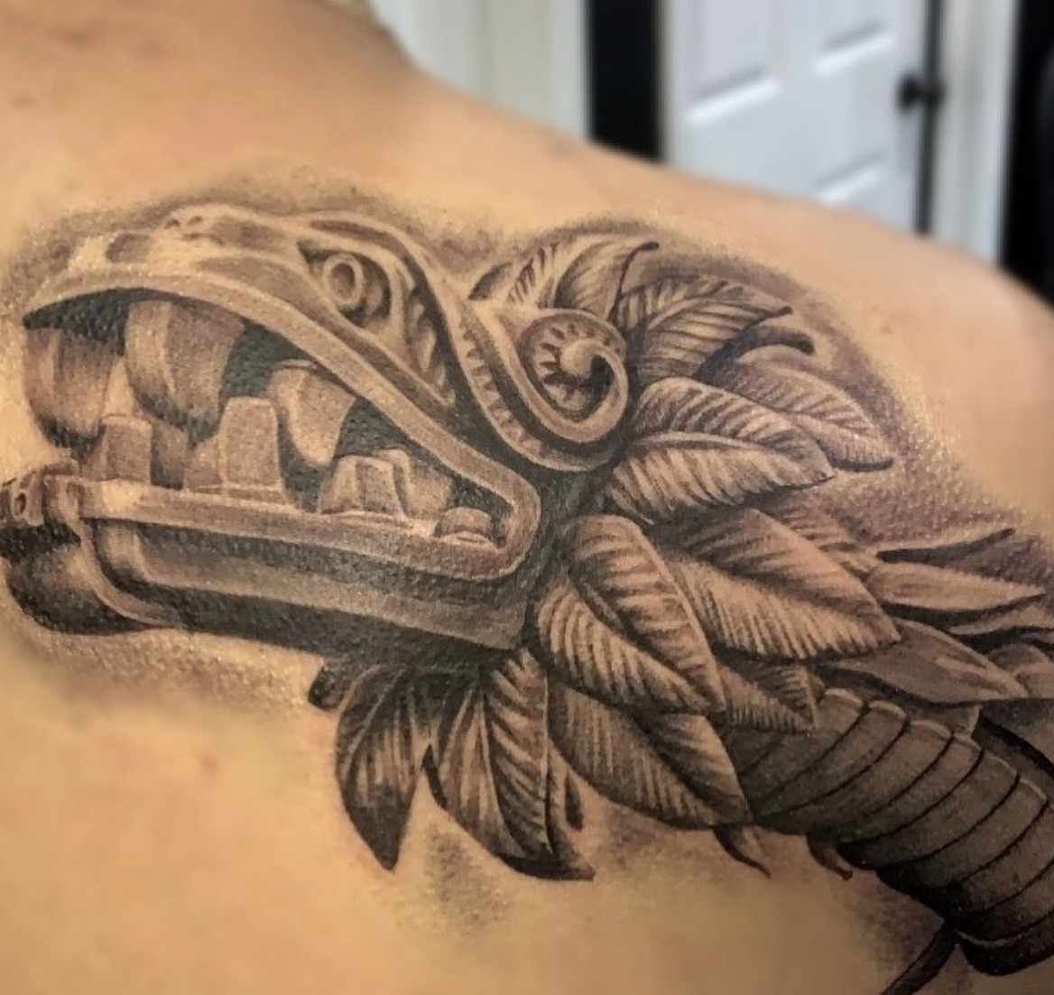 Aztec feathered serpent dragon tattoo style