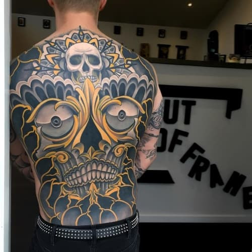 A upper back tattoo with geometric design on a man's upper back, stylish and modern