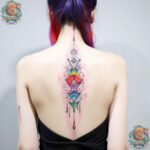 Detailed floral spine tattoo for women, embodying feminine elegance and baddie style.
