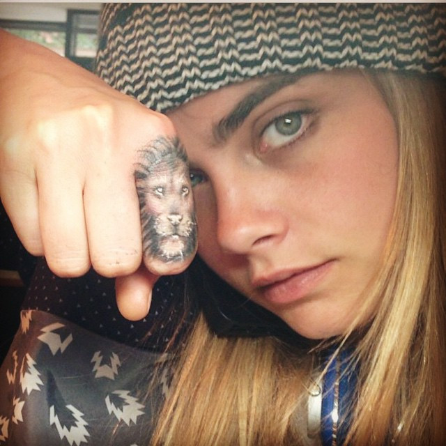 Lion finger tattoo symbolizing courage and strength