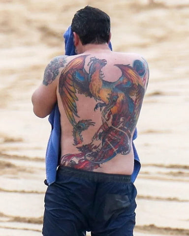 Ben Affleck back tattoo, a large, colorful phoenix covering his entire back, symbolizing rebirth and transformation.