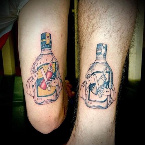 Matching best friends tattoos with similar designs on arms, symbolizing friendship bond