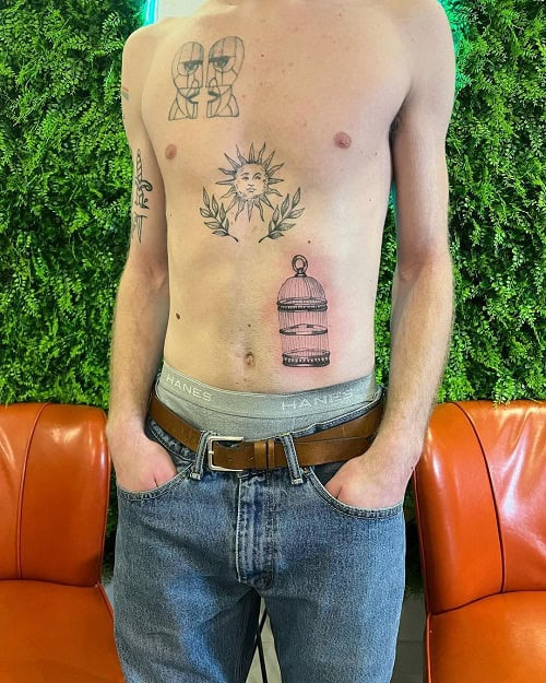 Symbolic bird cage tattoo for men, representing breaking free from limitations and achieving personal growth