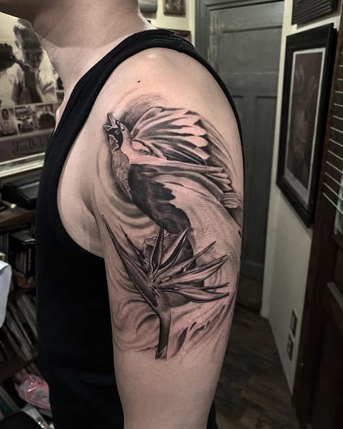 Vibrant bird of paradise flower tattoo for men, symbolizing individuality and exotic beauty