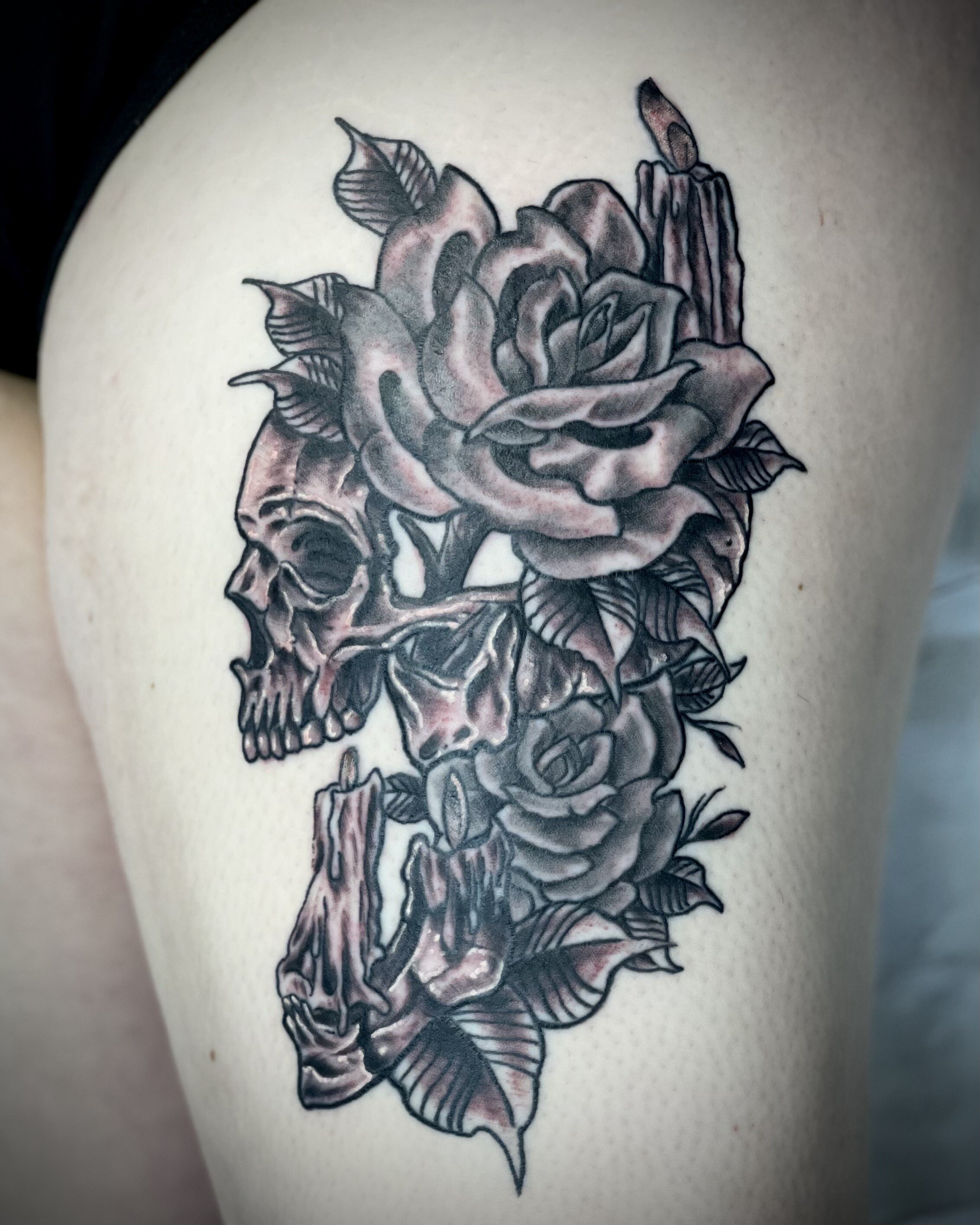 Black and grey floral tattoo with skull for women