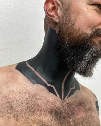 Black full neck tattoo with intricate linework and shading