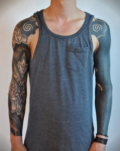 Blackout sleeve tattoo covering the entire arm in solid black ink