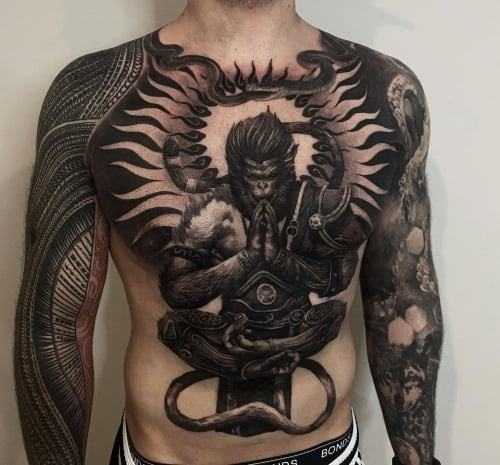 Two blackwork tattoos on men, one on the chest with a stylized blackwork mandala and another on the shoulder with a geometric blackwork tribal design.