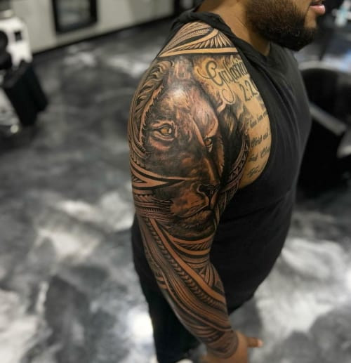 Blackwork sleeve tattoo design for men, showcasing an extensive and detailed tattoo covering the entire arm.