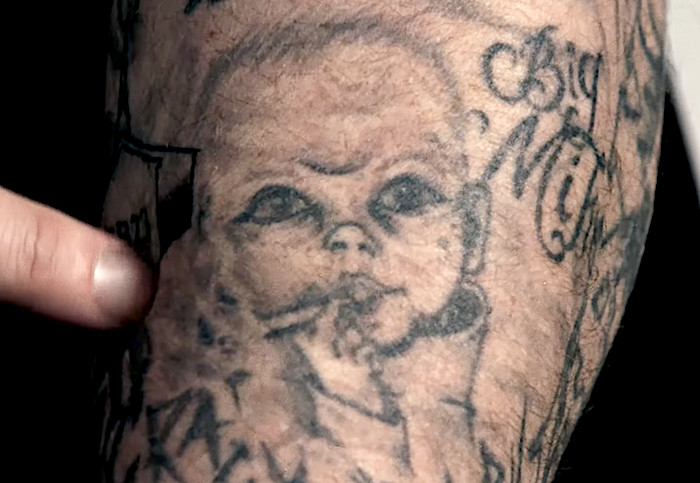 Close-up of Jelly Roll's &quot;blunt baby&quot; tattoo, part of his collection he openly regrets.